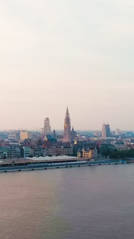 Vertical video. Antwerp, Belgium. Panorama overlooking the Cathedral of Our Lady (Antwerp). Historical center of Antwerp. City is located on the river Scheldt (Escaut). Summer morning, Aerial View. R