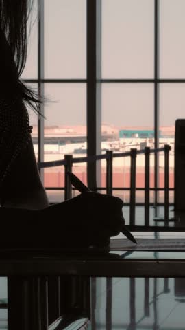 Medical questionnaire. at the airport. silhouette of woman fills out documents. close-up. new rules and restrictions after coronavirus epidemic end. Resumption of flights, open borders