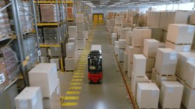 A top-down view of a warehouse reveals a black autonomous forklift navigating between rows of stacked boxes, highlighting efficient logistics and automation in a vast storage facility. - Powered by Shutterstock - Get 15% off with code: PIKWIZARD15