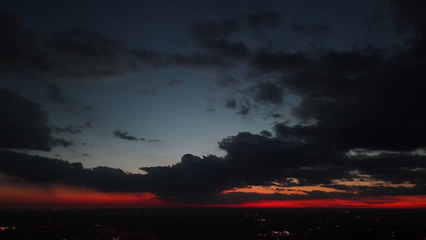 An aerial view of cityscape of Waterloo, Ontario illuminated in the evening under a scenic cloudy dusk sky, Canada