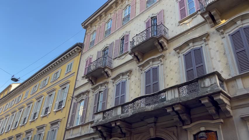 Elegant residential building in Milan featuring classic Italian architecture, ornate balconies, and timeless facades in a historic urban neighborhood