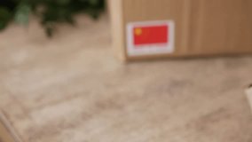 Man Hands applying MADE IN China flag label on a shipping cardboard box. - Powered by Shutterstock - Get 15% off with code: PIKWIZARD15