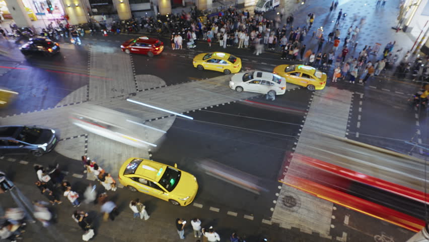 Many asian pedestrian wait traffic light cross busy road time lapse. Crowded city street rush hour China. Lot chinese people hurry up. High speed transport move timelapse. Cars drive urban crossroad.