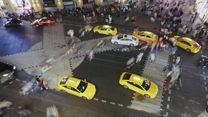 Many asian pedestrian wait traffic light cross busy road time lapse. Crowded city street rush hour China. Lot chinese people hurry up. High speed transport move timelapse. Cars drive urban crossroad.