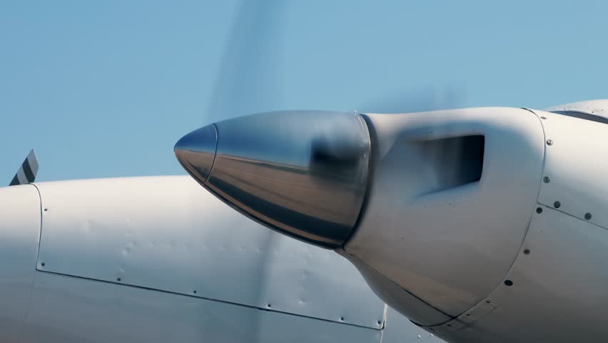 Close-up view of rotating propeller engine of twin turbo light airplane. Front - Side view of spinning blades