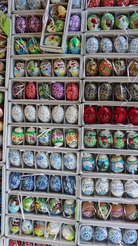Vertical screen colorful Easter eggs hand painted with folk art patterns cute animals flowers and ornaments packed in rows vibrant traditional style festive and playful atmosphere