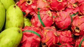 Organic produce on market shelf showing fresh harvest and natural nutrition Bright display of fruits including vibrant pitahayi Pitahayi stands out with vivid color Healthy lifestyle with pitahayi  - Powered by Shutterstock - Get 15% off with code: PIKWIZARD15