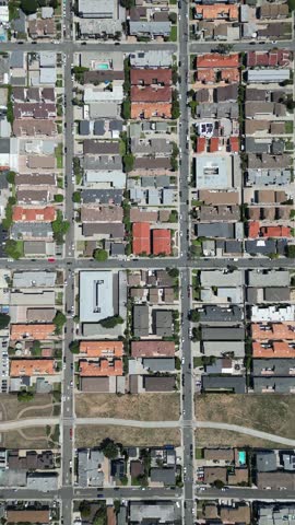 4K top-down aerial drone footage of a sunny California neighborhood. Palm tree lined streets, rooftops, and parked cars form a perfect city grid—ideal for urban planning, travel, or real estate.