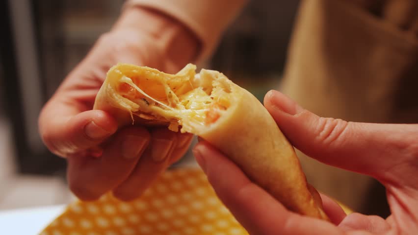 Woman eating empanadas argetinian pie, Samosa tart, traditional bakery from argentina, chef filling dough in home with meat and vegetables, homemade spanish empanadas