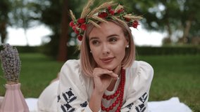 A serene portrait of a woman in nature, elegantly adorned with a floral crown and traditional attire - Powered by Shutterstock - Get 15% off with code: PIKWIZARD15