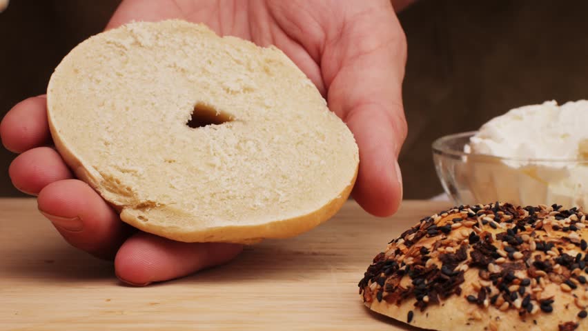 Bagel sandwich brunch, lunch plate of a bagel with smoked salmon and cream cheese and ham, close up morning cafe menu.