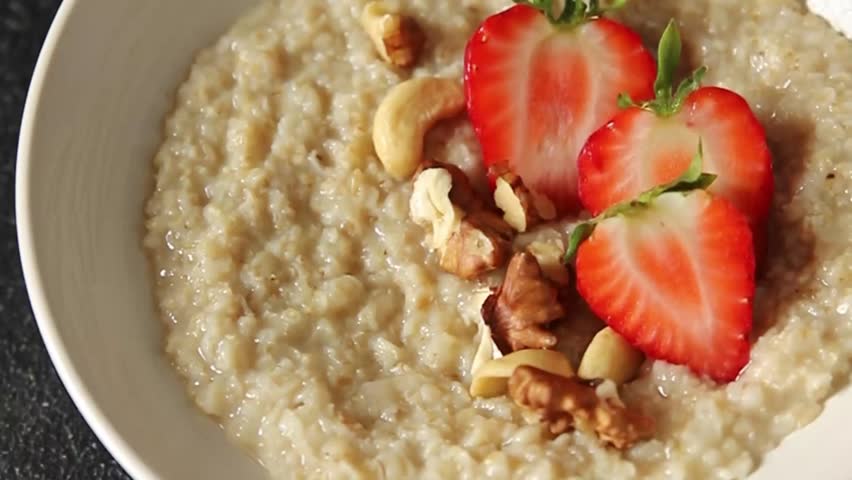 Oatmeal porridge strawberrie nuts healthy breakfast appetizer dish fresh gourmet food background on the table rustic food top view copy space