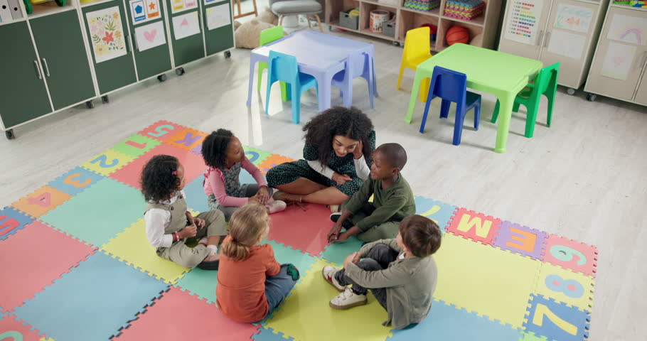 Woman, teacher and learning with kids above in nursery for activity, education or listening skills at kindergarten. Female person, educator or instructor with children in sing along, class or school
