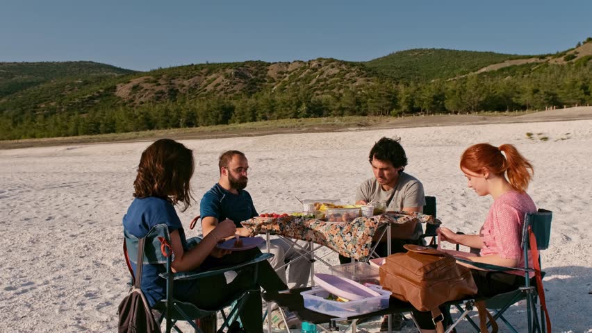“Casual Outdoor Gathering by the Sea at Dusk”