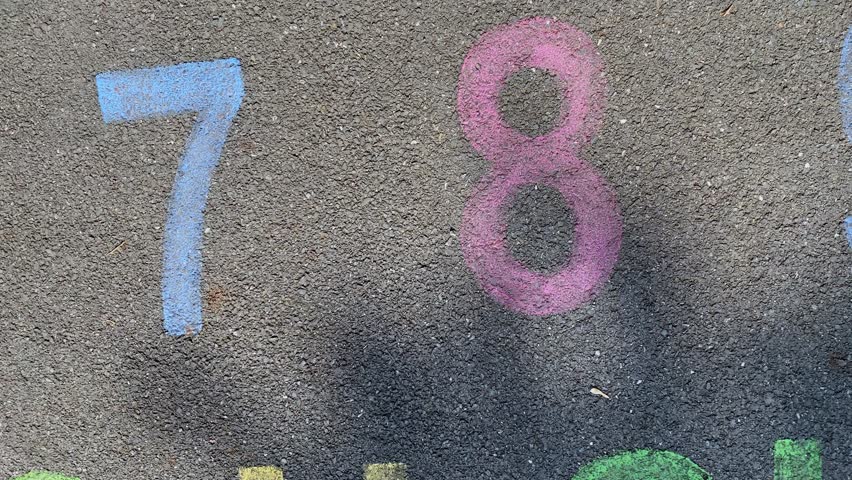 alphabet and numbers are drawn with color paint on a children's asphalt playground to learn and play. the alphabet educational element learning space. Vertical video