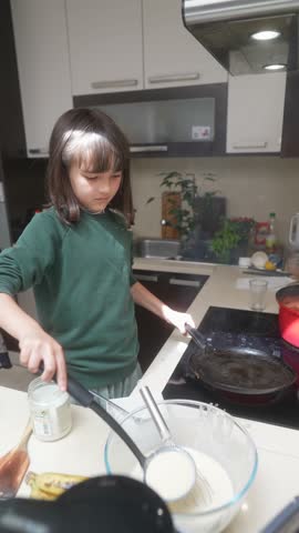 A Young Kid Joyfully Cooking Delicious Pancakes in a Modern and Cozy Kitchen Setting