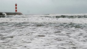 Video still shot of the raging Mediterranean Sea in the south of France. Waves on a stormy day invading the beach of Port La Nouvelle in Aude in Occitania. - Powered by Shutterstock - Get 15% off with code: PIKWIZARD15