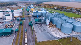 Modern agricultural enterprise with railways across it. Large silo tanks for grain storage in the rural area. Aerial view. - Powered by Shutterstock - Get 15% off with code: PIKWIZARD15