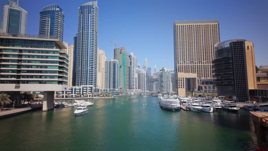 Amazing skyscrapers of dubai marina. Great perspective of multiple tallest skyscrapers with yachts and boats. United Arab Emirates. Dubai Marina with skyline - luxury and famous 