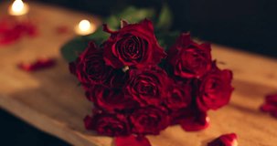 Roses, table and romantic for anniversary, restaurant and gift for date on valentines day and closeup. Commitment, bouquet and flowers for celebration of love, petal or floral arrangement for present - Powered by Shutterstock - Get 15% off with code: PIKWIZARD15