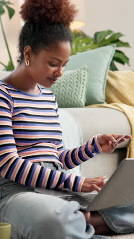 Happy, black woman and laptop with credit card on sofa for online shopping, payment or banking app at home. Female person, user or shopper with smile on computer for ecommerce or remote purchase