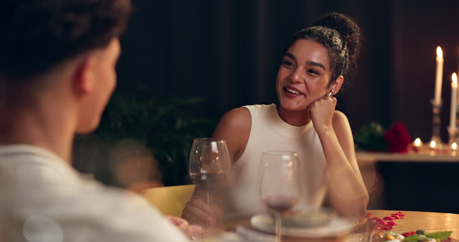 Restaurant, drinking and couple on date, bonding and conversation for valentines day, wine and smile. Night, man and woman with drink for anniversary, food and romance for people with commitment