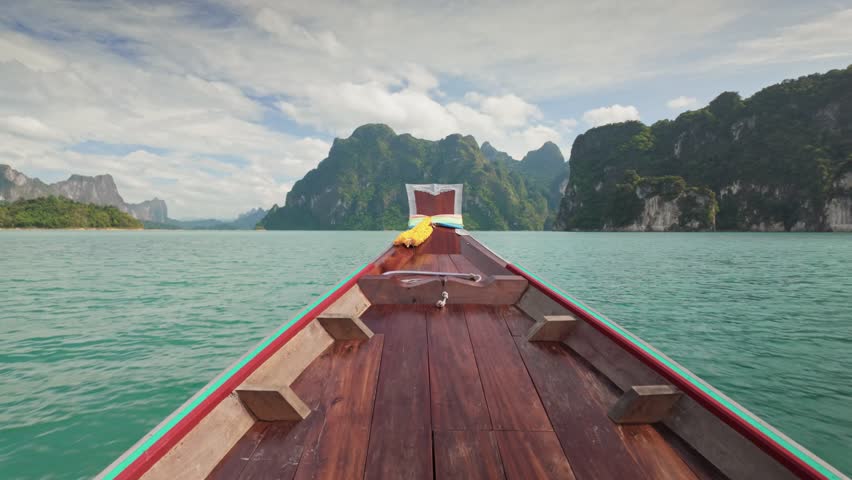 Boat trip on Cheow Lan Lake, Khao Sok National Park, Surat Thani Province, South of Thailand. Aerial view shows green mountain islands of Khao Sok National Park in Surat Thani, Thailand