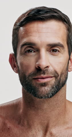 Studio, shine and skincare for man, cosmetics and facial treatment for moisture of skin, face or dermatology. White background, grooming and person with routine for self care, beauty and smile in USA