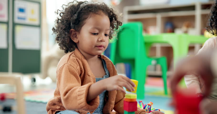 Child, student and stack blocks in classroom for learning, problem solving and creative activity. Kid, talk and building toys for education game, puzzle solution and motor development in kindergarden