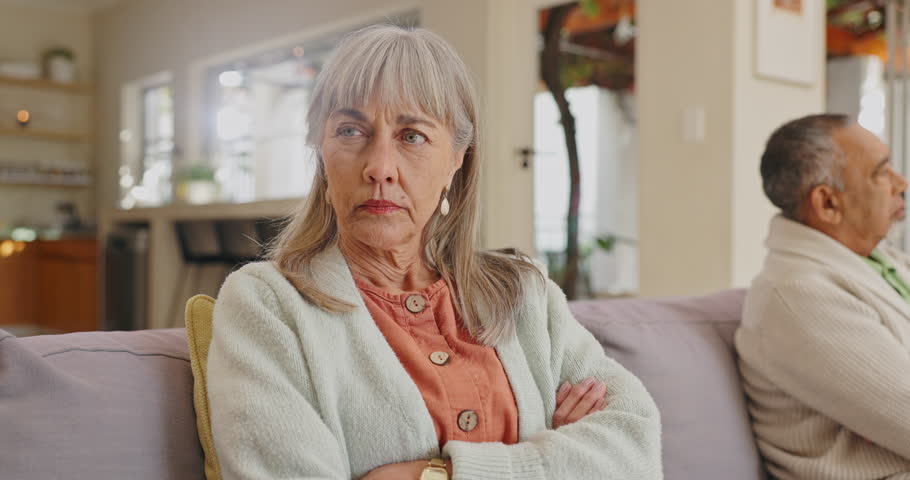 Frustrated, angry and face of senior woman or disappointment from argument, fight and disagreement with husband. Elderly female person, mature man and couple with diversity not talking to each other