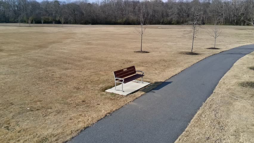 Short video with a drone circling a bench in a wacky manner. 