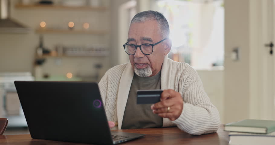 Senior man, credit card and laptop for payment in home, ecommerce and internet banking for transaction. Elderly male person, finance and typing account number on website, online and investment