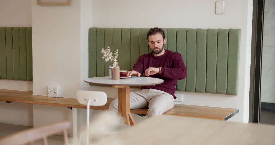 Man, check watch and cafe with worry for meeting, thinking and waiting for client with coffee cup. Person, time management and freelance business consultant with clock for schedule at restaurant