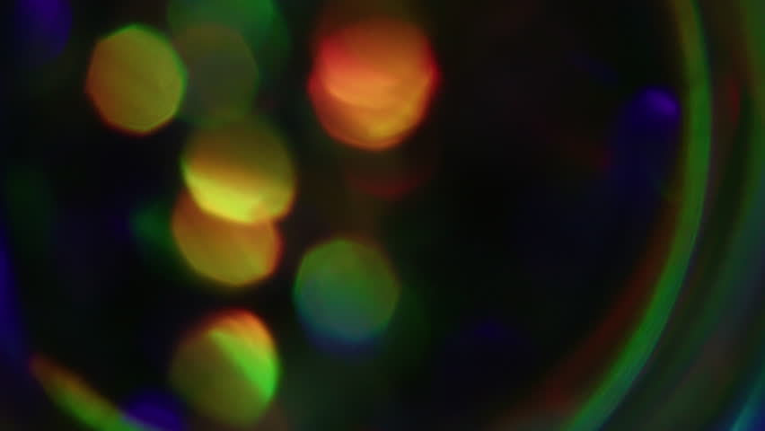 Blur rays. Glitter light. Defocused leak multicolor green yellow rainbow flickers beam lens flare on abstract art dark black bokeh background.