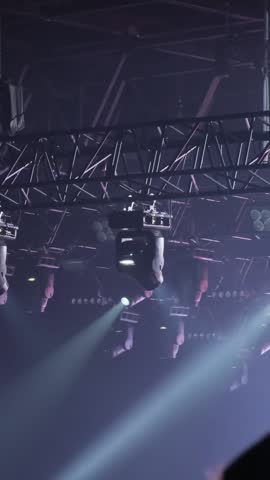 Stage lighting frame with lantern blocks on the ceiling. Bright shiny stage lights flashing movement entertainment spotlight projectors in the dark, white color beam of light spotlight