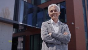 Confident senior businesswoman standing outside modern office building - Powered by Shutterstock - Get 15% off with code: PIKWIZARD15