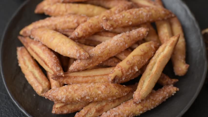 Cinnamon flavored biscuits or breadsticks as a food background.