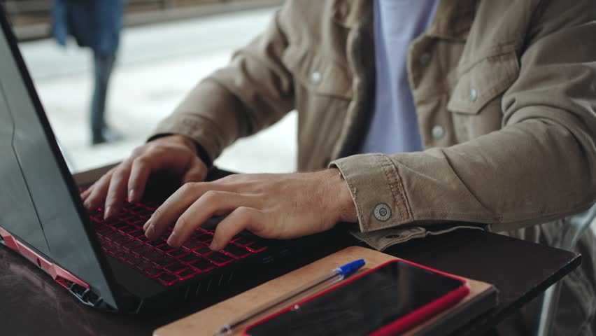  University student freelancer working on laptop sitting cafe in the college campus