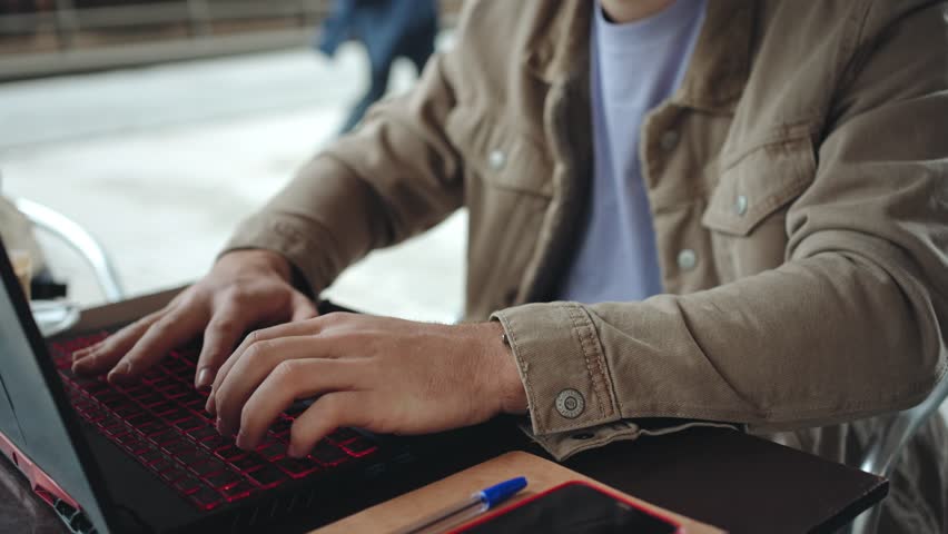  University student freelancer working on laptop sitting cafe in the college campus