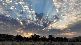 Dramatic Sunset Crepuscular Rays over Silhouetted Landscape - Powered by Shutterstock - Get 15% off with code: PIKWIZARD15