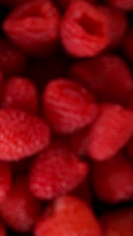 Super Slow Motion Shot of Exploding Fresh Raspberries . Filmed on High Speed Cinematic Camera at 1000fps .