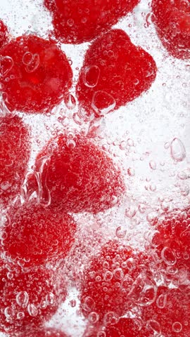 Super Slow Motion of Pouring Mineral Water into Glass with Ice Cubes and Fruit . Filmed on High Speed Cinema Camera , 1000fps