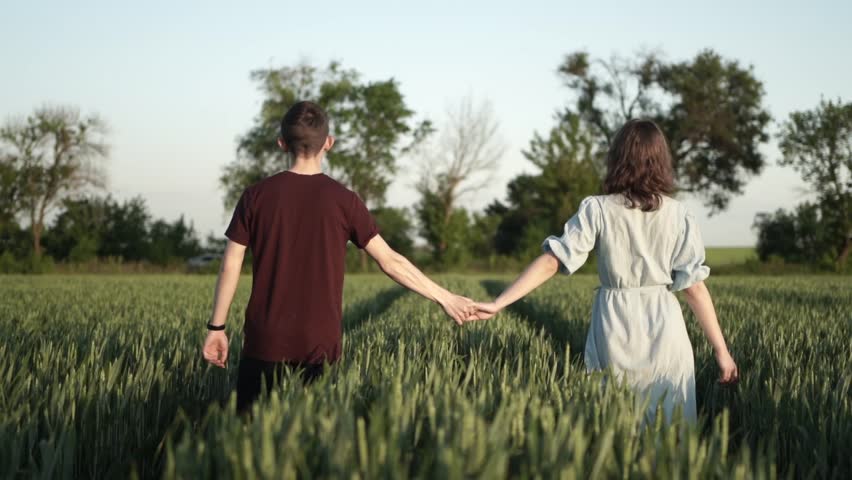 Girl and Boy Holding Hands - Couple at Sunset