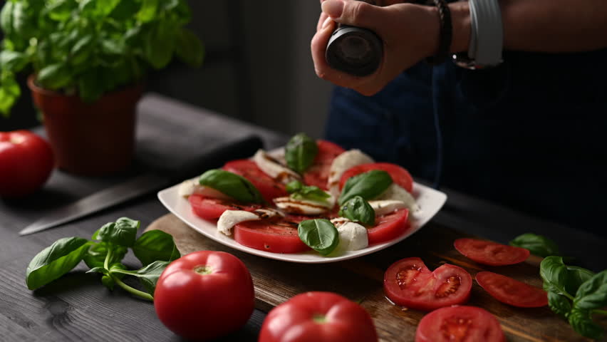 Girl Adding Spices To A Fresh Veggie Caprese Salad
