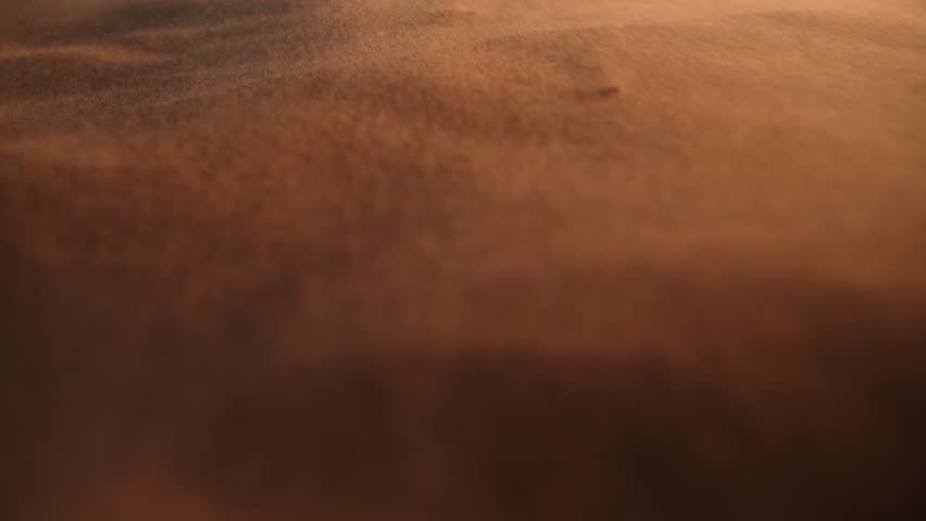 Wind Blowing Across Sand Dune Surface On Desert Landscape In Essaouira, Morocco. closeup shot