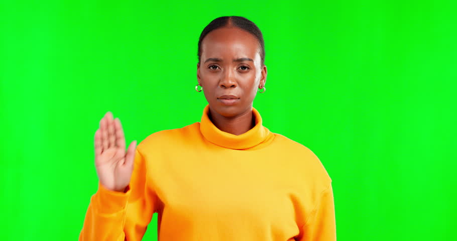 Portrait, stop and hand gesture with a black woman on a green screen studio background for gender equality. Palm, warning and protest with an angry female saying no to gender based violence