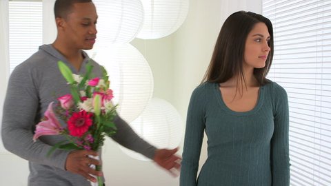 African American man giving girlfriend bouquet