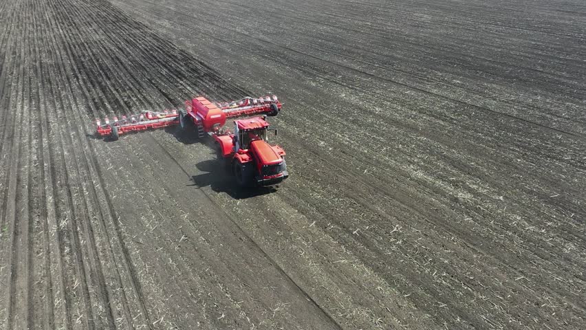HD. Tractor with a sowing complex works in the field