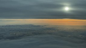 An aerial pilot’s POV of a sunrise recorded from inside a jet cockpit while flying between ethereal layers of clouds, with the sun veiled by stratus clouds. - Powered by Shutterstock - Get 15% off with code: PIKWIZARD15