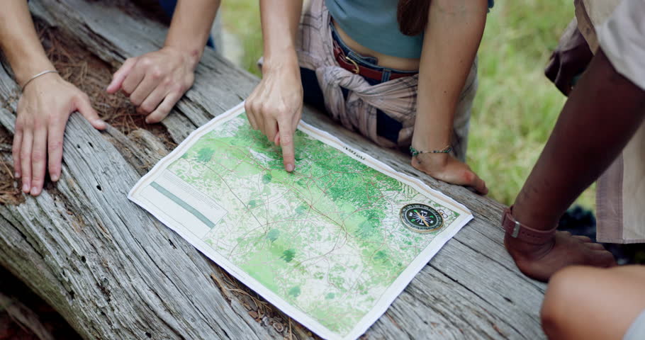 Hands, people or map in woods for hiking, travel planning or pointing in direction. Friends, trekking break or chart on tree for navigation, above or search for location to explore forest with guide